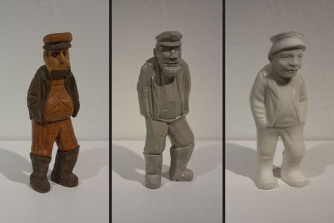 three carvings of the same old man in wood, plastic, and marble